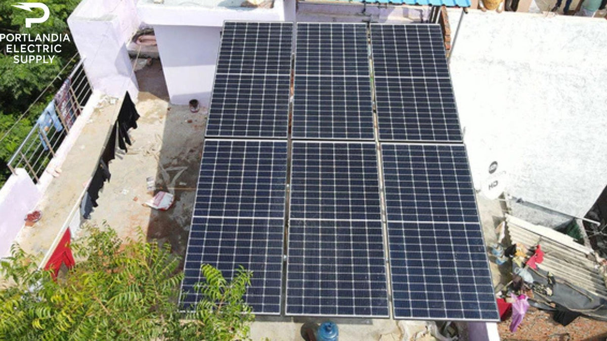 Rooftop solar panels installation on a building with Portlandia Electric Supply logo