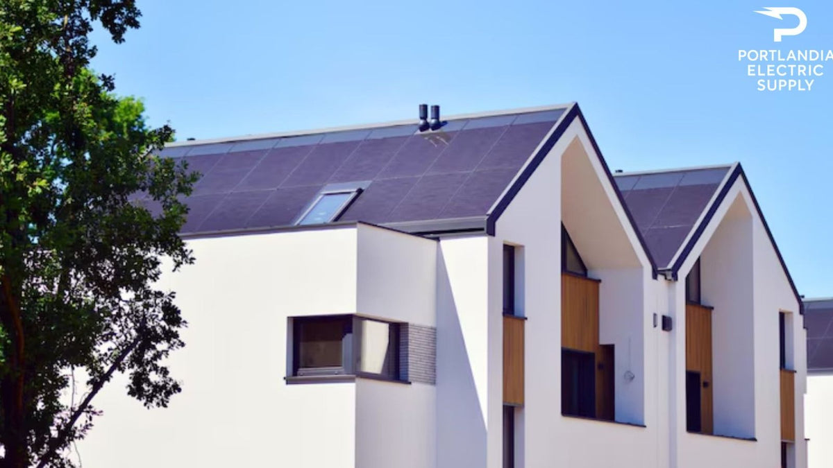 Modern house with solar panels on roof, blue sky, Portlandia Electric Supply logo