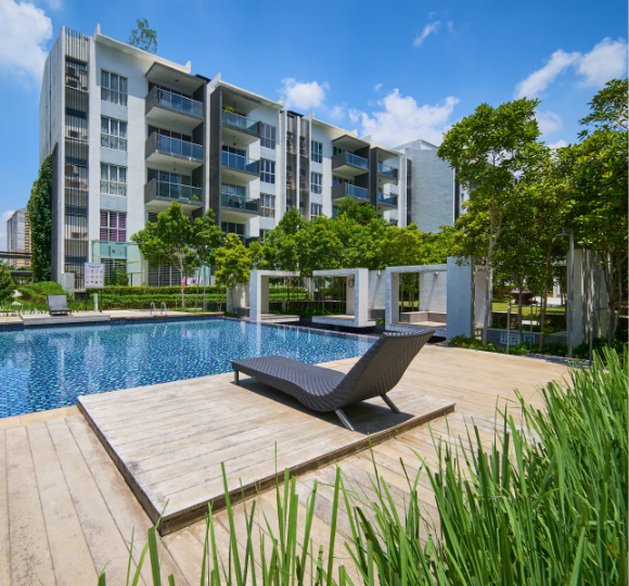 Pool area with lounge chair and modern apartment building in the background