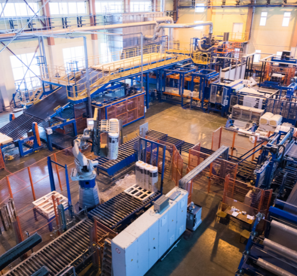 Large industrial warehouse with conveyor belts and storage racks.